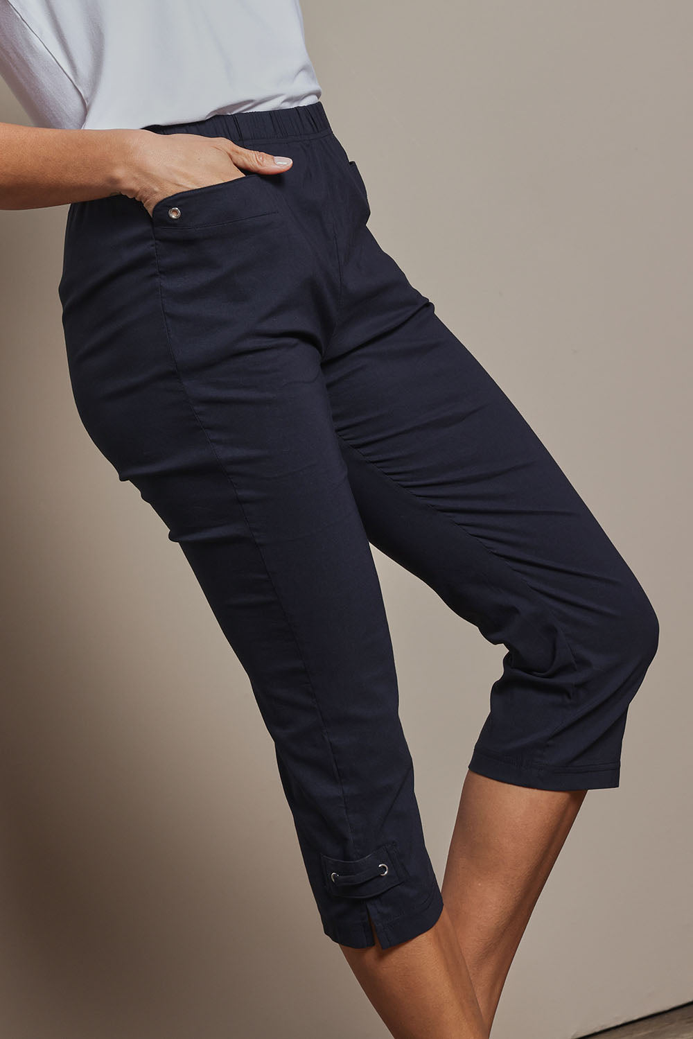 Model Amanda wearing size 10 of The Pull On Elastic Waist Cotton Blend Capri Pant in colour Navy (Blue), from the front, cropped image