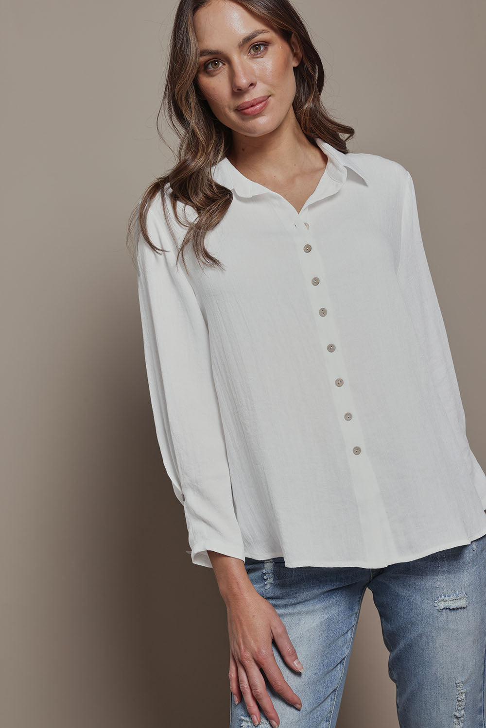 Model Madeline wearing size 10 of The Must Have Linen Look Shirt in colour White (White), from the front, cropped image