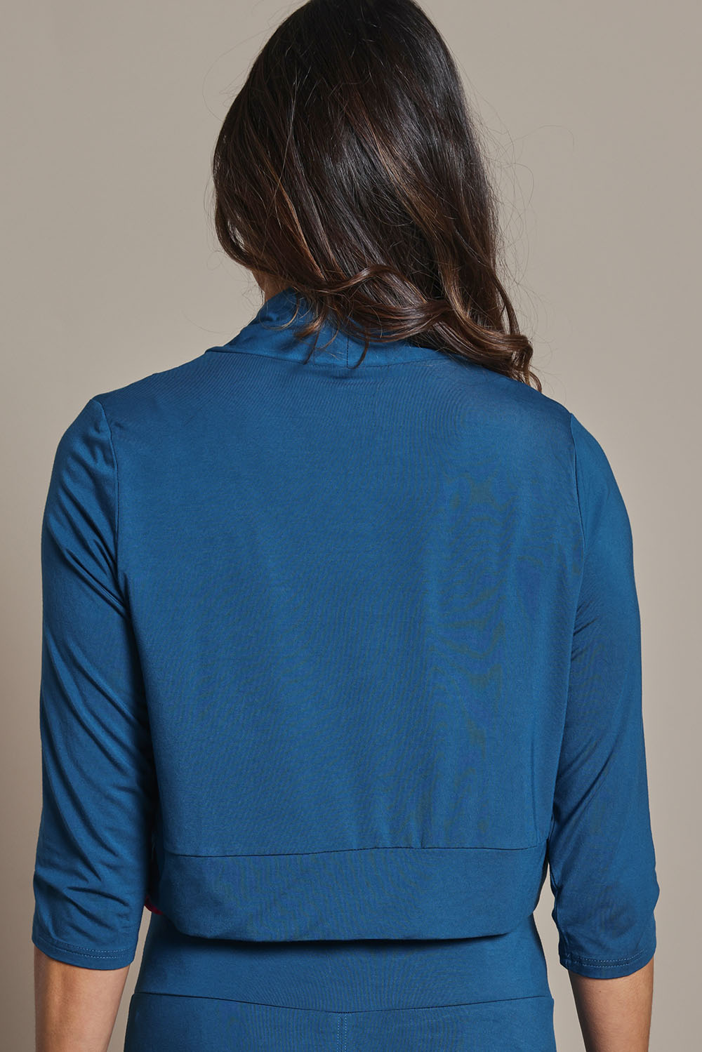 Model Amanda wearing size 10 of The Mix Me Match Me Bamboo Shrug in colour Marine (Blue), from the back