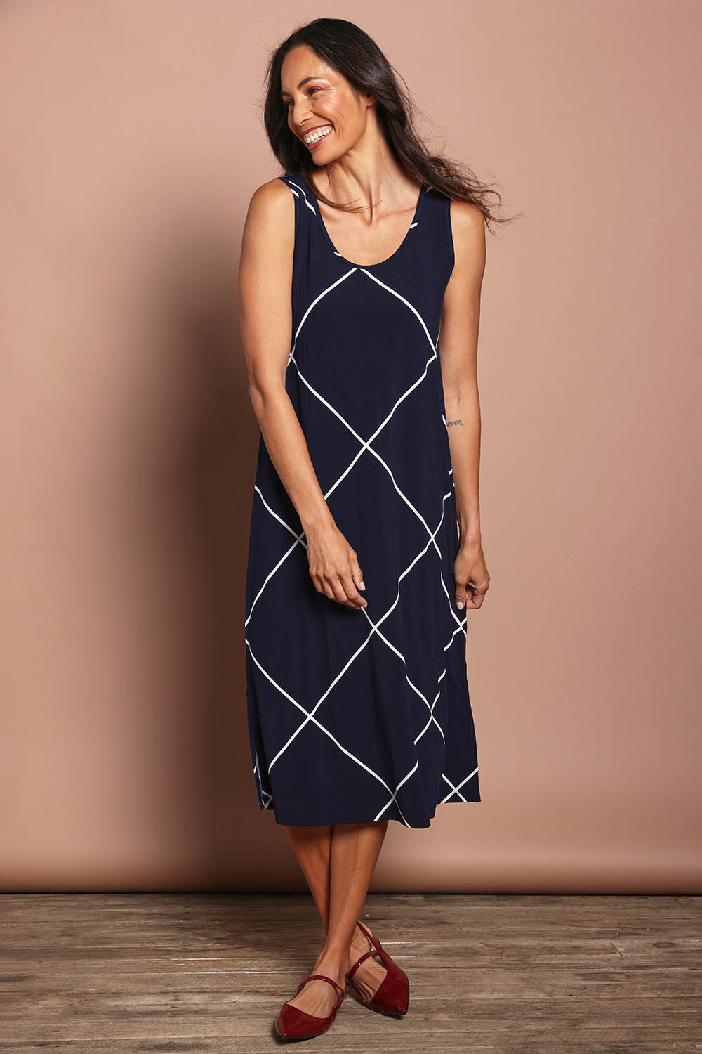 Model Amanda wearing size 10 of The Easy Wear Printed Tank Dress in colour Navywhite (Blue), from the front, showing the whole outfit
