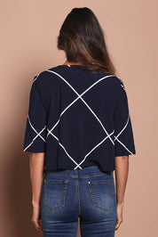 Model Amanda wearing size 10 of The Easy Wear Printed Shrug in colour Navywhite (Blue), from the back