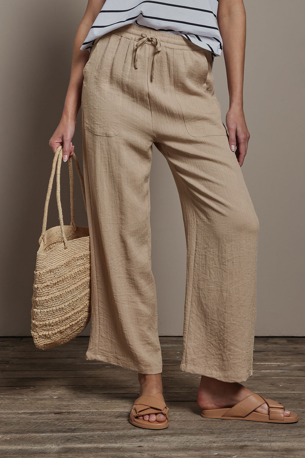 Model Madeline wearing size 10 of The Must Have Linen Look Pull on Pant in colour Biscotti, from the front, cropped image