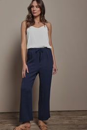 Model Madeline wearing size 10 of The Must Have Linen Look Pull on Pant in colour Darknavy (Blue), from the front, showing the whole outfit
