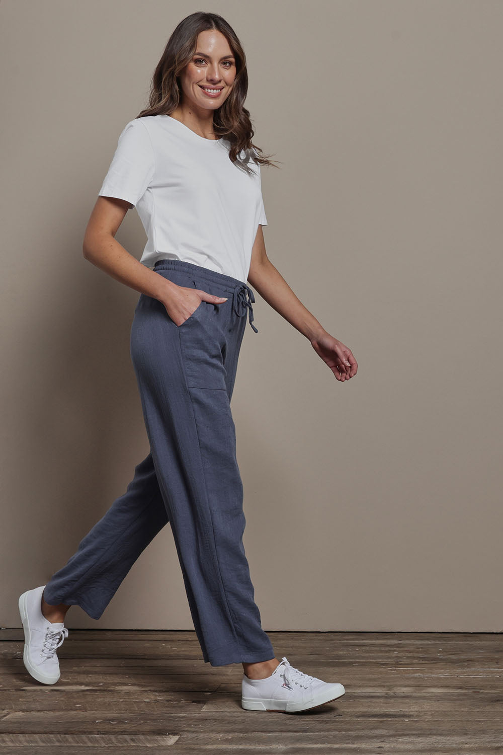 Model Madeline wearing size 10 of The Must Have Linen Look Pull on Pant in colour Denim (Blue), from the front, showing the whole outfit