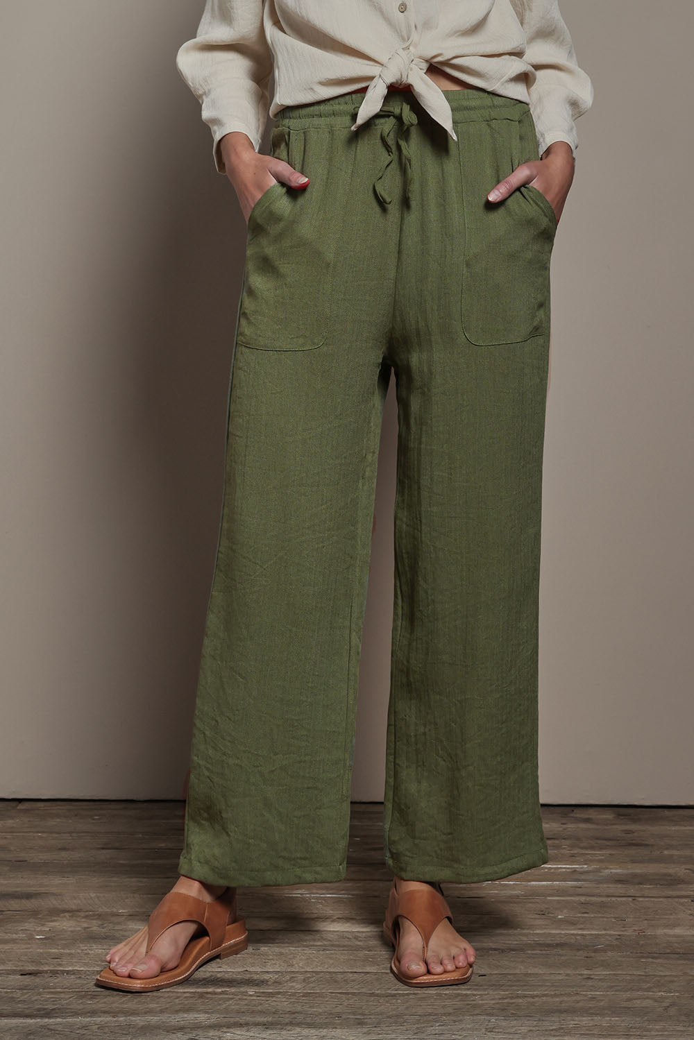 Model Madeline wearing size 10 of The Must Have Linen Look Pull on Pant in colour Kkahi (Green), from the front, cropped image