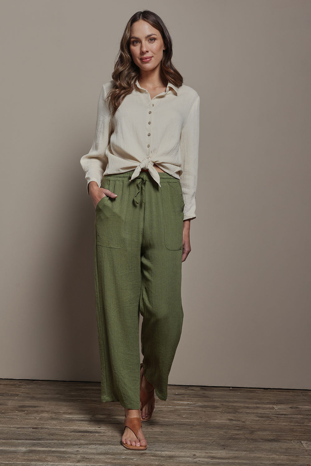 Model Madeline wearing size 10 of The Must Have Linen Look Pull on Pant in colour Kkahi (Green), from the front, showing the whole outfit