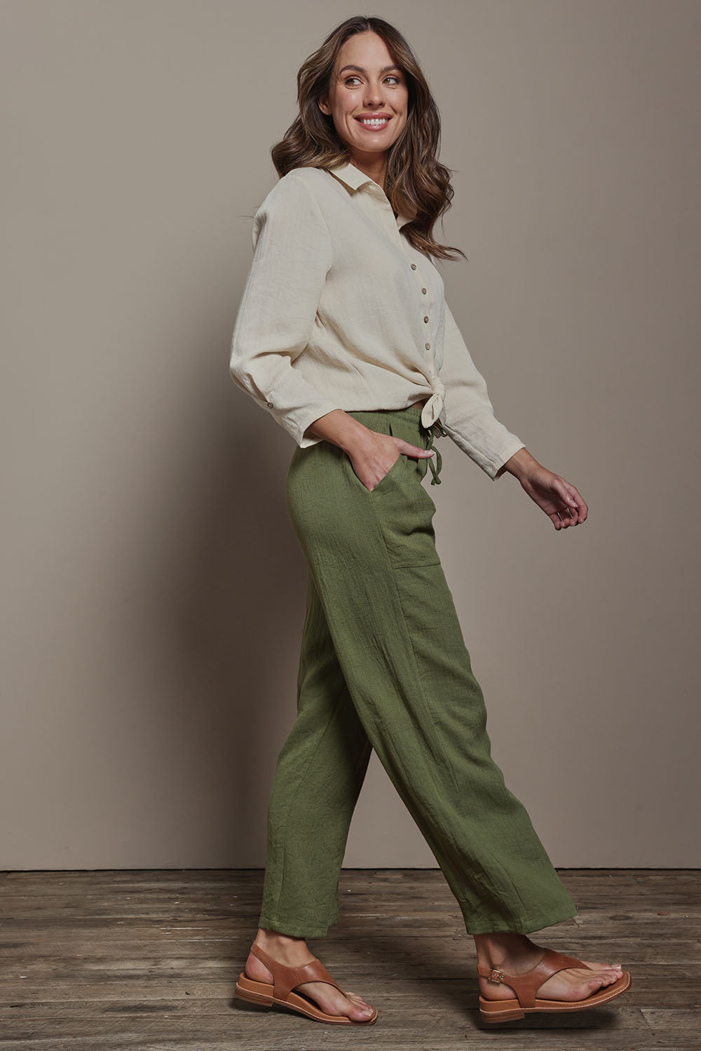 Model Madeline wearing size 10 of The Must Have Linen Look Pull on Pant in colour Kkahi (Green), from the front, showing the whole outfit