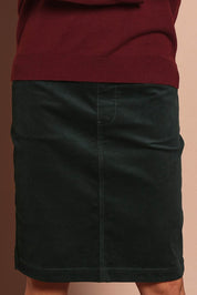 Model Amanda wearing size 10 of The Keepers Cord Pull On Skirt in colour Deepforest (Green), from the front, cropped image