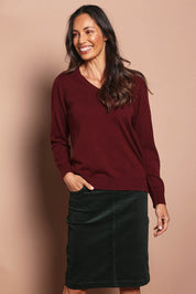 Model Amanda wearing size 10 of The Keepers Cord Pull On Skirt in colour Deepforest (Green), from the front, cropped image