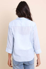 Model Amandam wearing size 10 of the The Easy Wear Shirt  - Chambray in colour Chambray, from the back