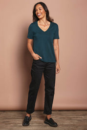 Model Nathalie wearing size 10 of The Teachers Pant With Pockets in colour Honorblack (Black), from the front, showing the whole outfit