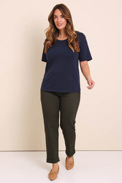Model Lauraw wearing size 14 of the The Teachers Cotton Pant With Pockets - Pinegrove in colour Pinegrove, from the front