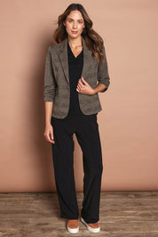 Model Madeline wearing size 10 of The Travel Wide Leg Pant in colour Black (Black), from the front, showing the whole outfit