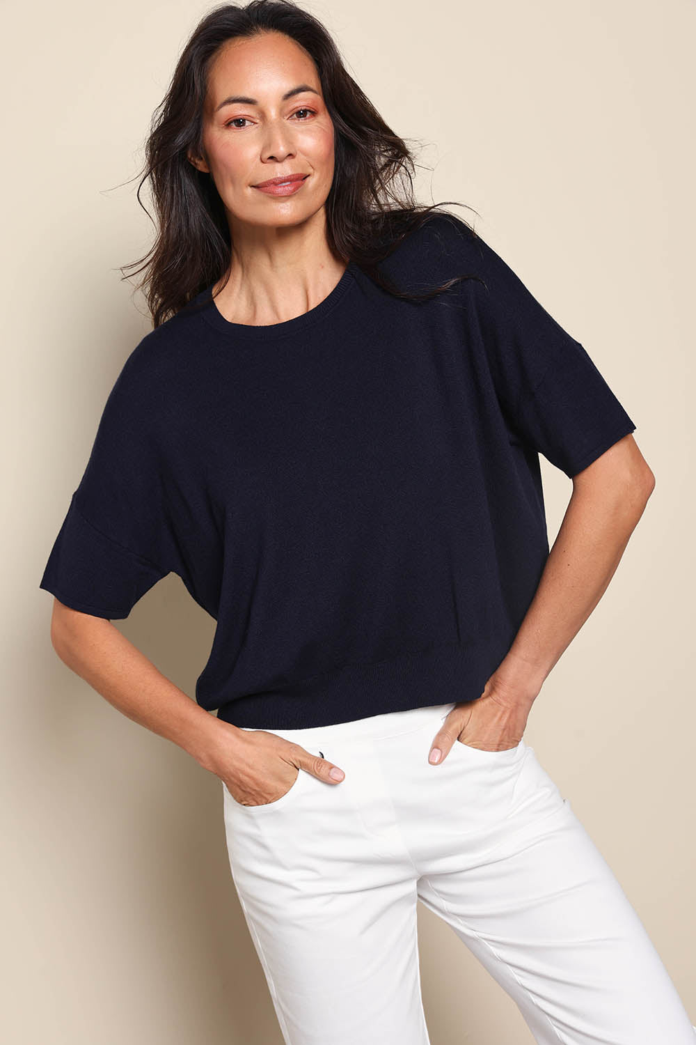 Model Amandam wearing size 10 of the The Essential Knit Tee – Darklapis in colour Darklapis, in a cropped view