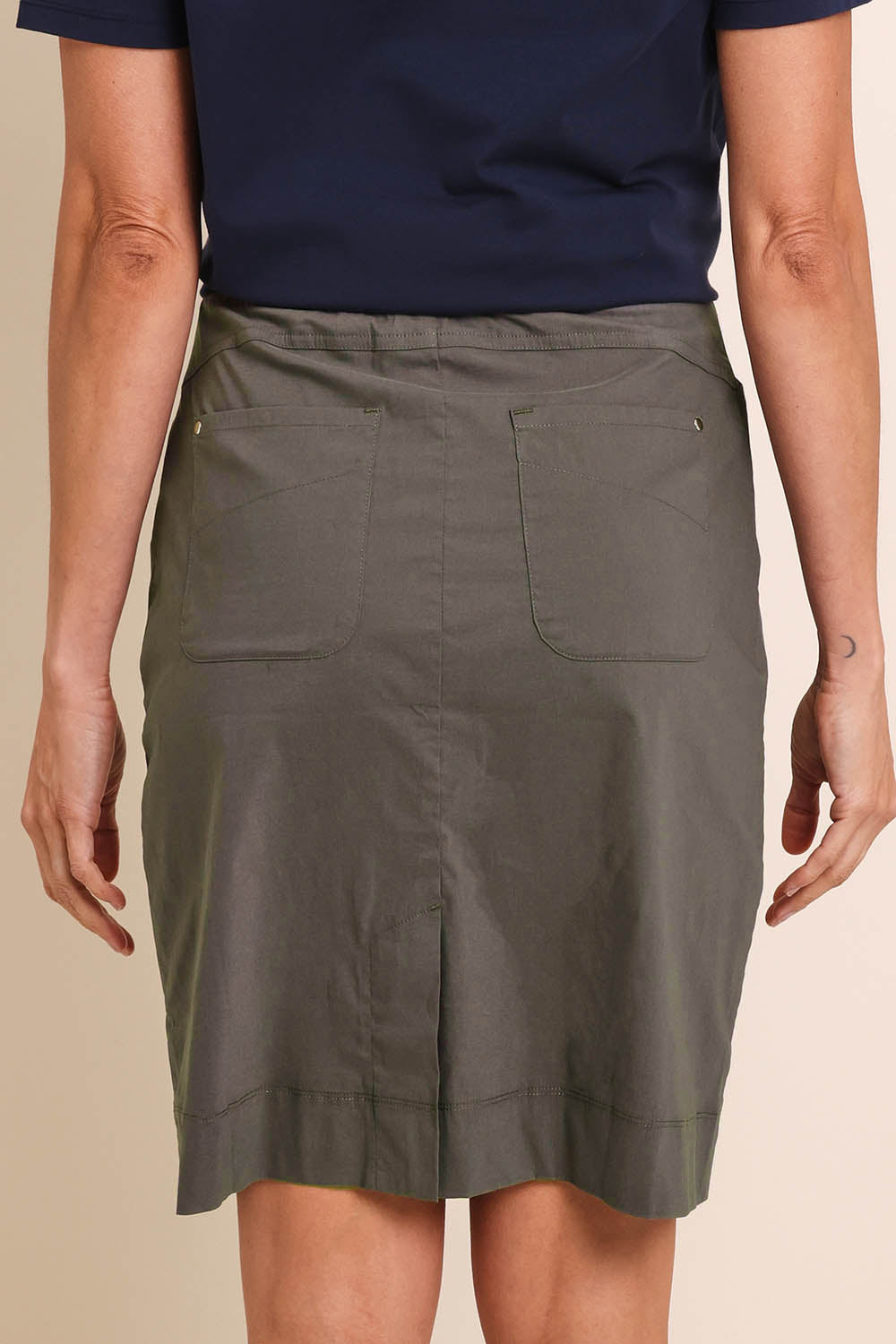 Model Amandam wearing size 10 of the The Lightweight Cotton Blend Stretch Skirt – Olive in colour Olive, from the back