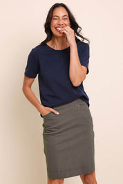 Model Amandam wearing size 10 of the The Lightweight Cotton Blend Stretch Skirt – Olive in colour Olive, in a cropped view