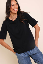 Model Amandam wearing size 10 of the The Keepers Relaxed Fit Tee – Black in colour Black, from an angle