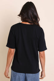 Model Amandam wearing size 10 of the The Keepers Relaxed Fit Tee – Black in colour Black, from the back