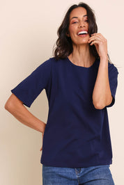 Model Amandam wearing size 10 of the The Keepers Relaxed Fit Tee – Navy in colour Navy, from an angle