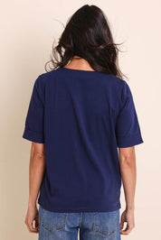 Model Amandam wearing size 10 of the The Keepers Relaxed Fit Tee – Navy in colour Navy, from the back