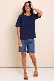 Model Amandam wearing size 10 of the The Keepers Relaxed Fit Tee – Navy in colour Navy, from the front