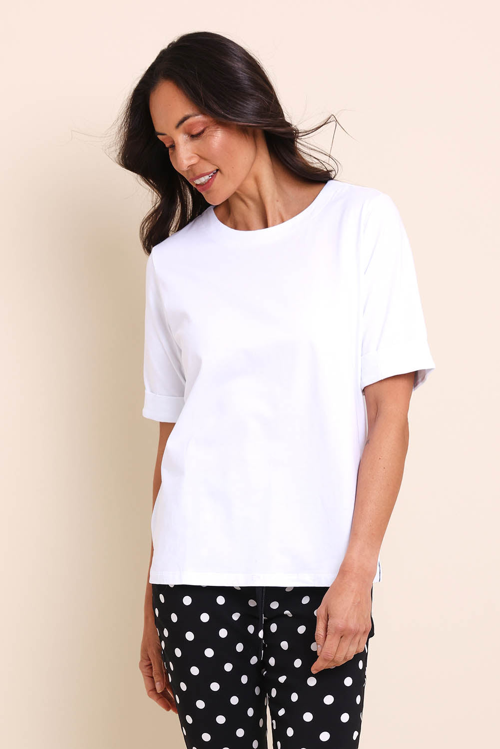 Model Amandam wearing size 10 of the The Keepers Relaxed Fit Tee – White in colour White, from an angle