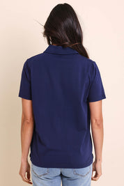 Model Amandam wearing size 10 of the The Keepers Polo Tee – Navy in colour Navy, from the back