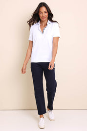 Model Amandam wearing size 10 of the The Keepers Polo Tee – White in colour White, from the front