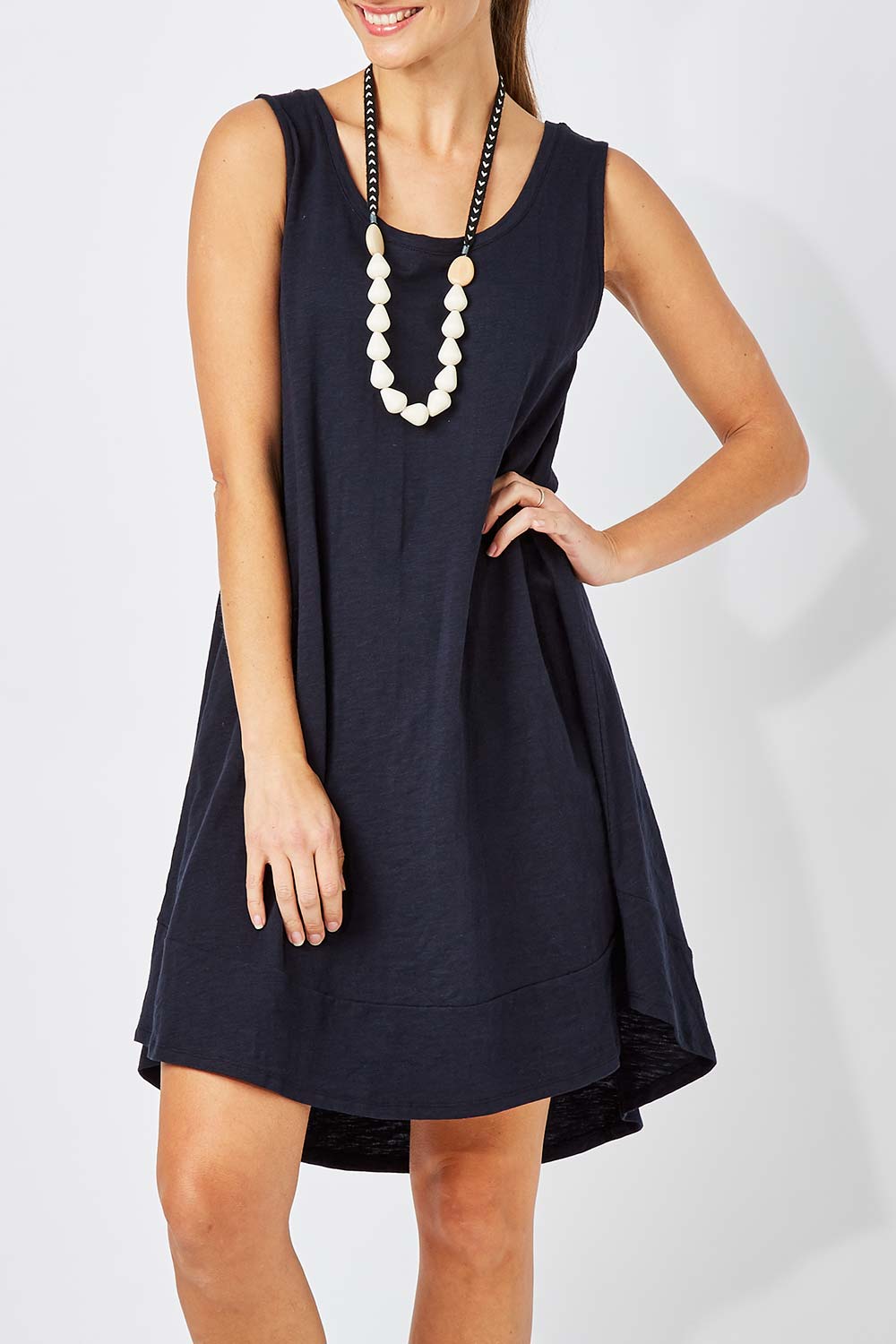 Model Anna wearing size 10 of The Sleeveless Swing Dress in colour WashBlack (Black), from the front, cropped image