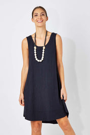 Model Anna wearing size 10 of The Sleeveless Swing Dress in colour WashBlack (Black), from the front, cropped image