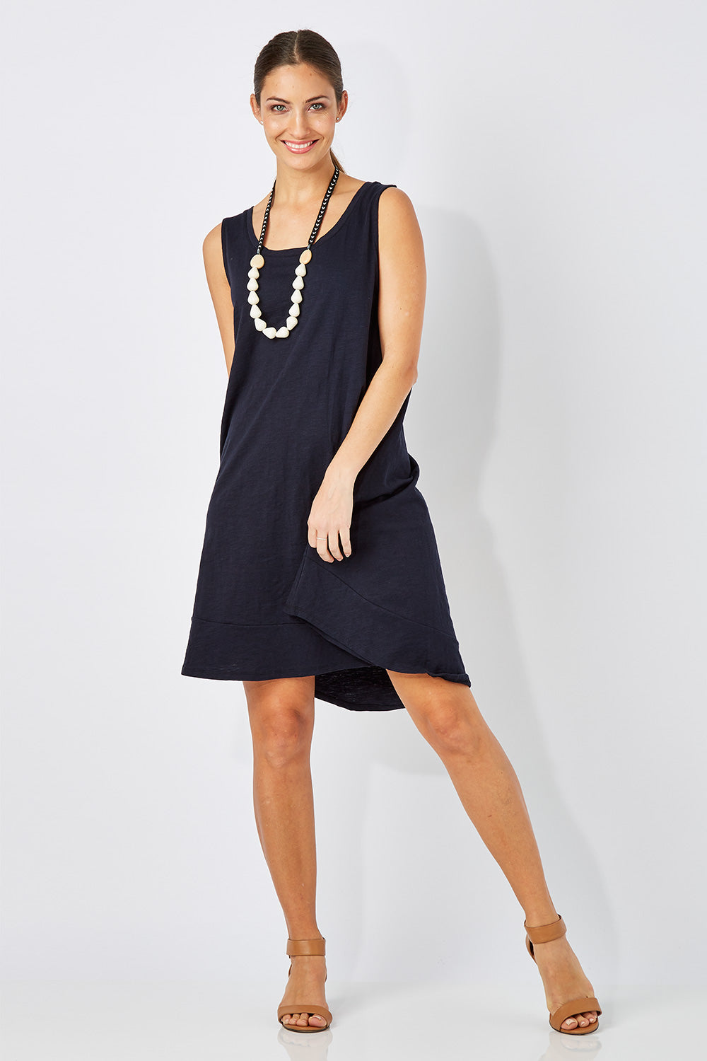 Model Anna wearing size 10 of The Sleeveless Swing Dress in colour WashBlack (Black), from the front, showing the whole outfit