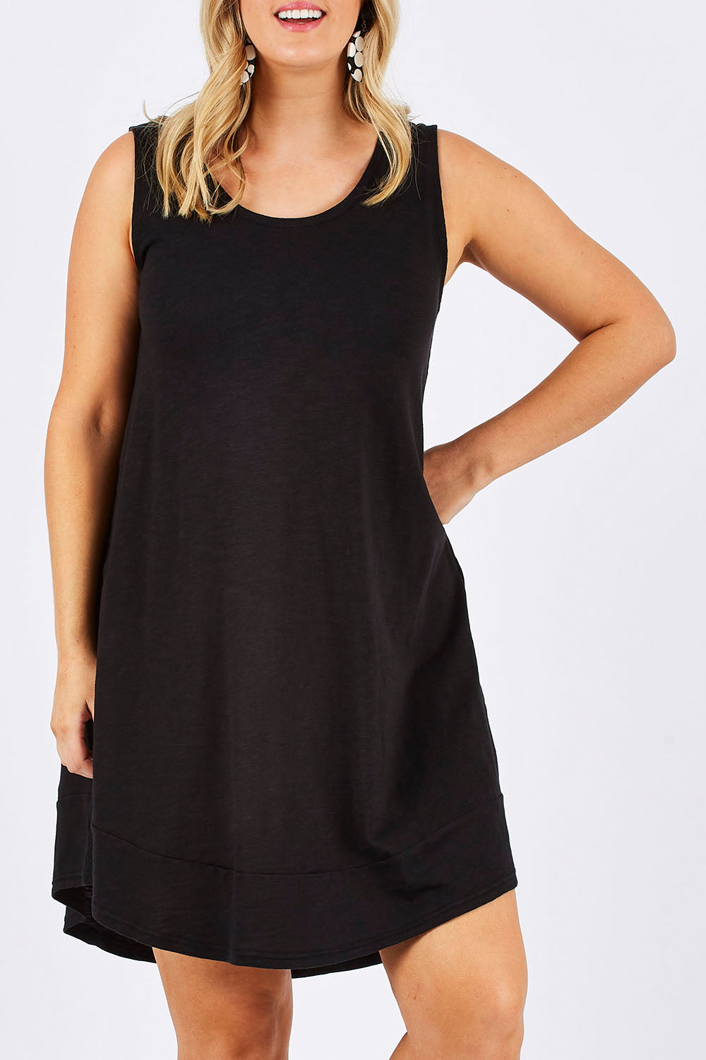 Model Jess wearing size 12 of The Sleeveless Swing Dress in colour WashBlack (Black), from the front, cropped image