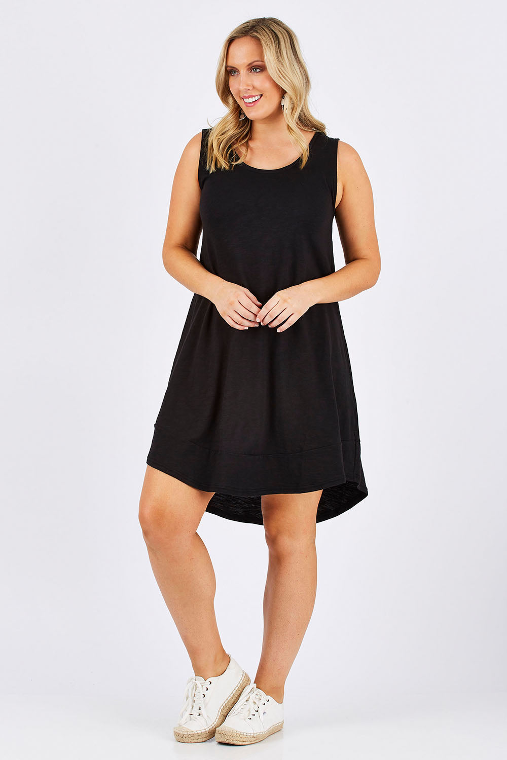 Model Jess wearing size 12 of The Sleeveless Swing Dress in colour WashBlack (Black), from the front, showing the whole outfit