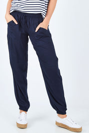 Model Chelsea wearing size 10 of The Soft Utility Pant in colour Navy (Blue), from the front, cropped image