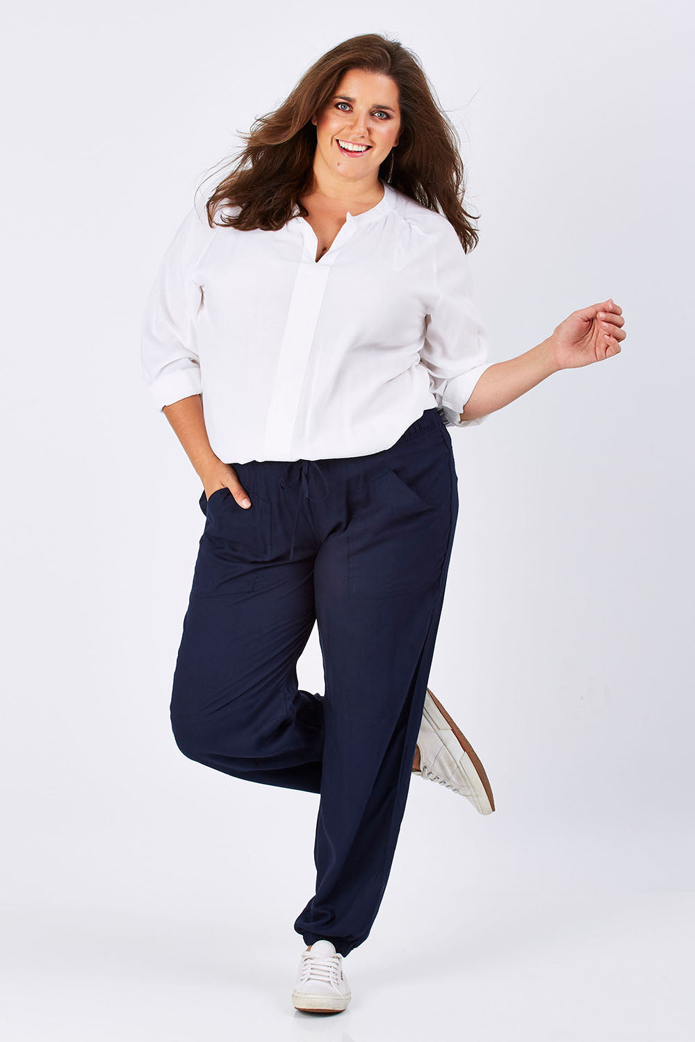 Model Mae wearing size 18 of The Soft Utility Pant in colour Navy (Blue), from the front, showing the whole outfit