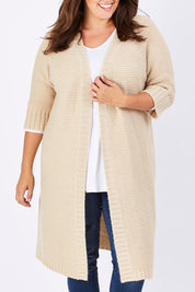 Model Mae wearing size XL of The Half Sleeve Cardigan in colour Oatmeal, from the front, cropped image