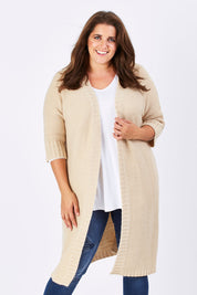 Model Mae wearing size XL of The Half Sleeve Cardigan in colour Oatmeal, from the front, cropped image