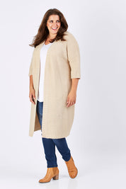 Model Mae wearing size XL of The Half Sleeve Cardigan in colour Oatmeal, from the front, showing the whole outfit