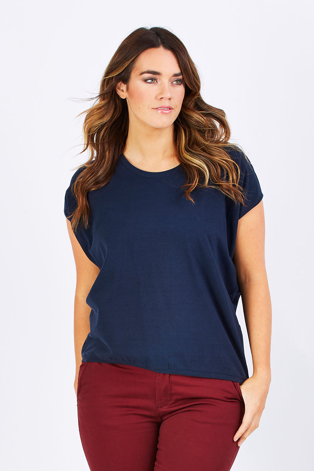Model Laura wearing size 12 of The Drape Tee in colour Navy (Blue), from the front, cropped image
