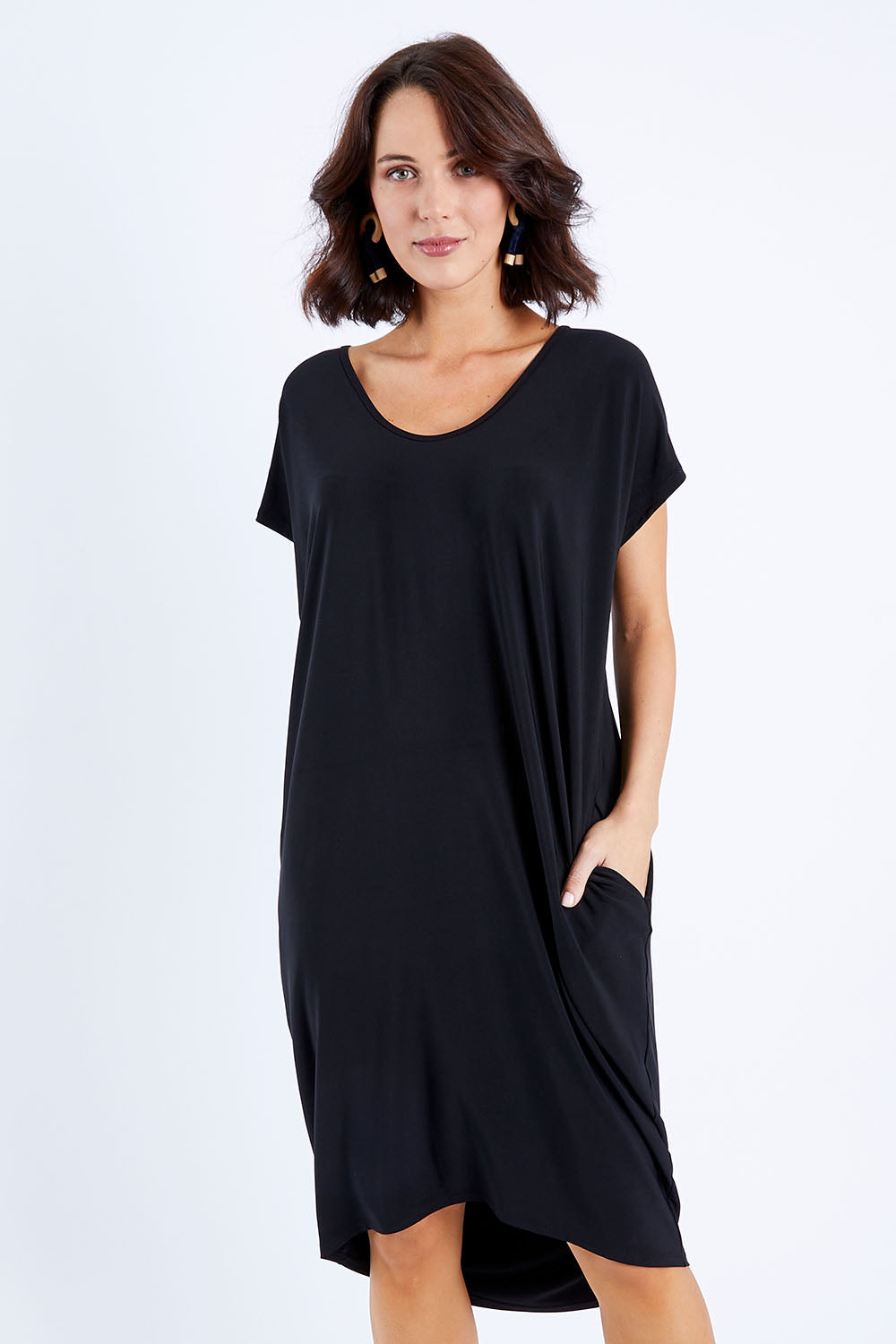 Model Andrea wearing size 10 of The Drape Jersey Dress in colour Black (Black), from the front, cropped image