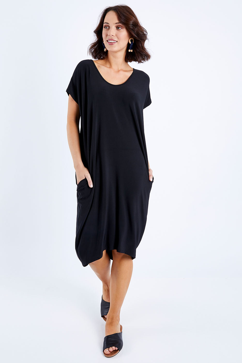 Model Andrea wearing size 10 of The Drape Jersey Dress in colour Black (Black), from the front, showing the whole outfit