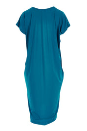 Product shot of The Drape Jersey Dress in colour Teal (Blue), from the back