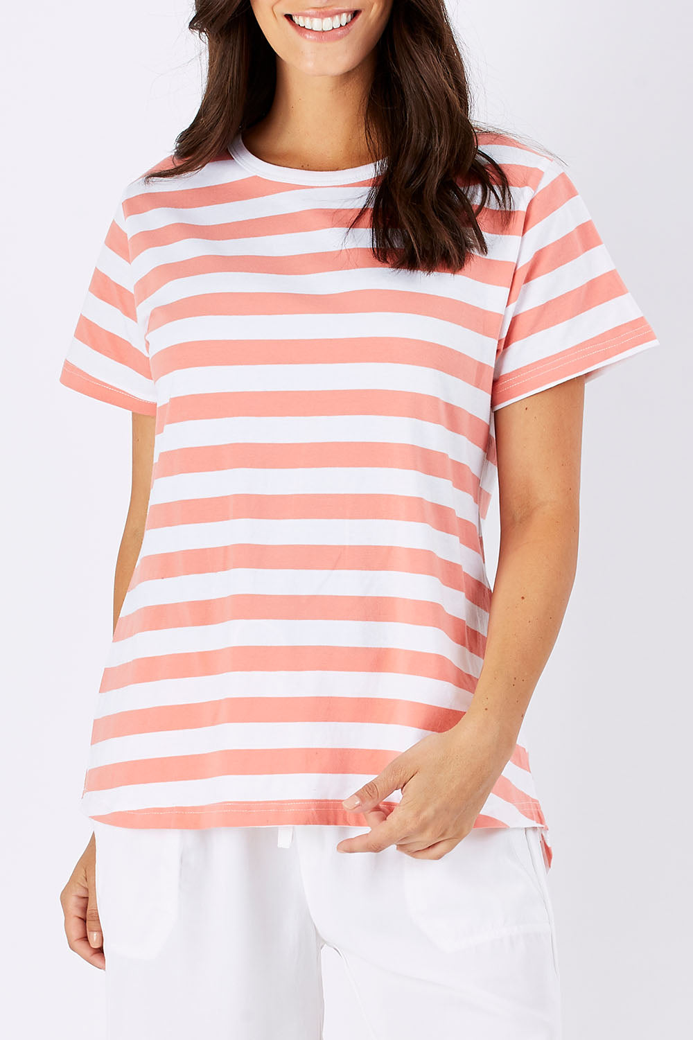 Model Georgia wearing size 10 of The Stripe Tee in colour PeachStrip (Pink), from the front, cropped image