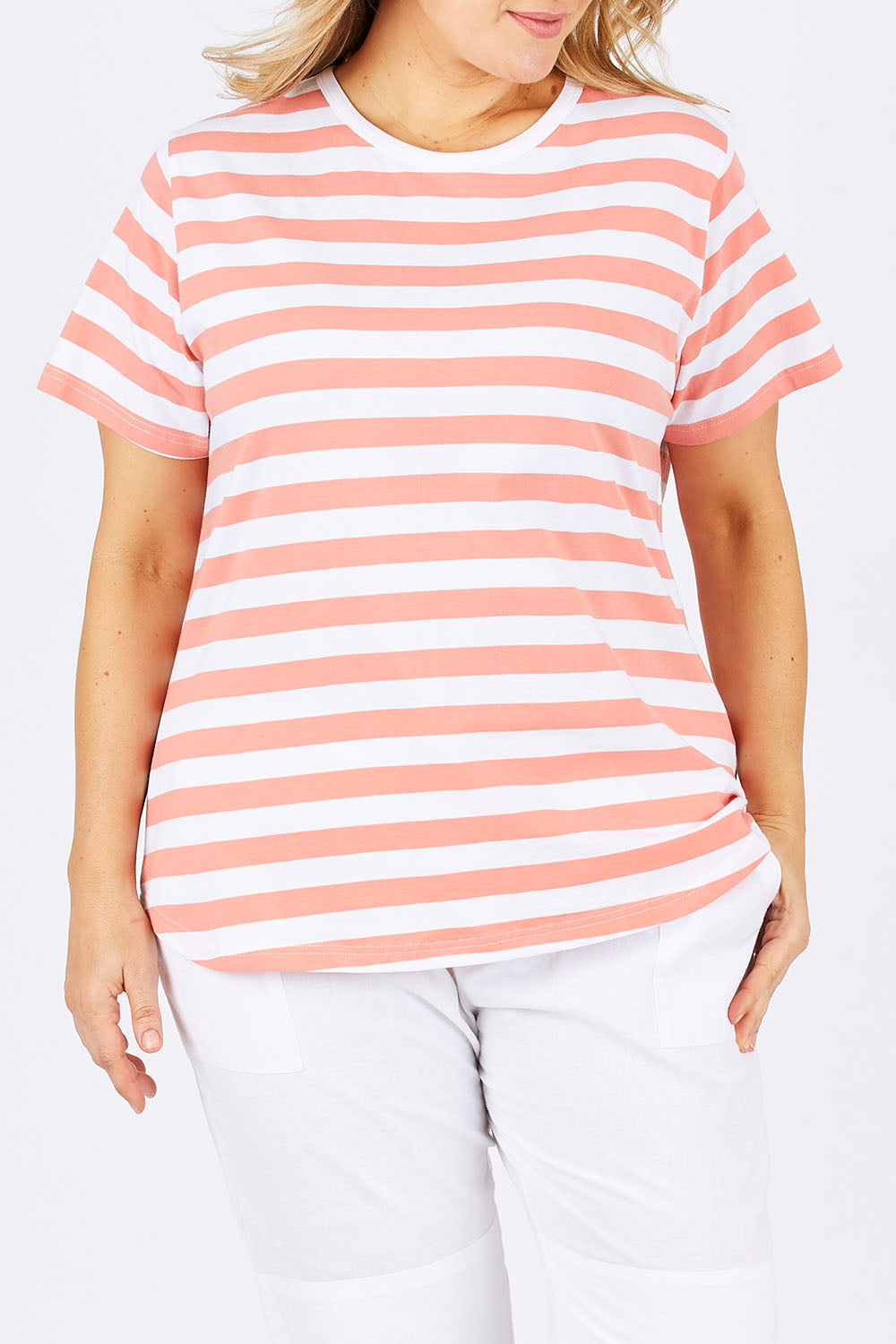 Model Ljubenka wearing size 18 of The Stripe Tee in colour PeachStrip (Pink), from the front, cropped image