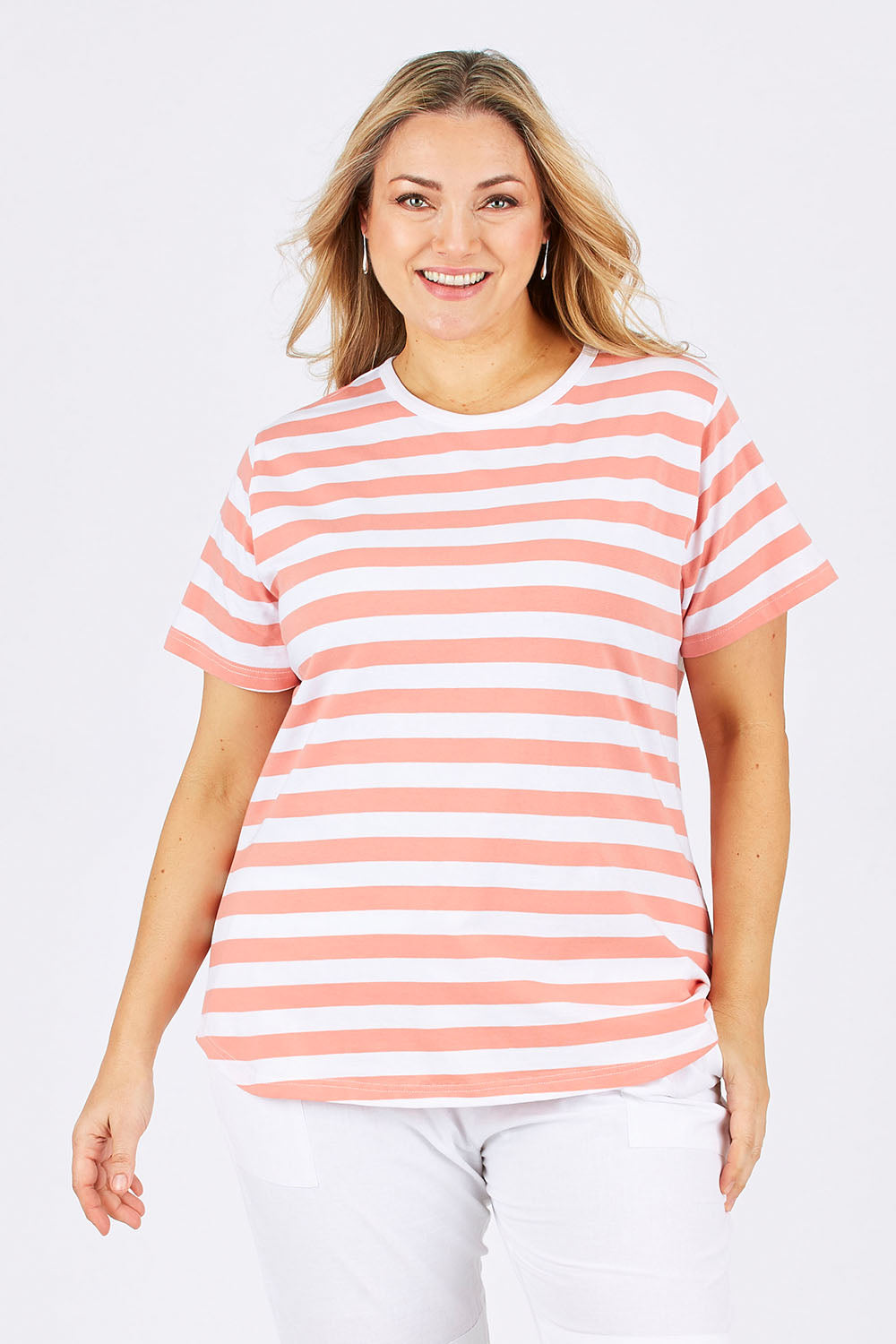 Model Ljubenka wearing size 18 of The Stripe Tee in colour PeachStrip (Pink), from the front, cropped image