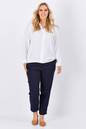 Model Jess wearing size 14 of The Soft Ankle Grazer Pant in colour Navy (Blue), from the front, showing the whole outfit