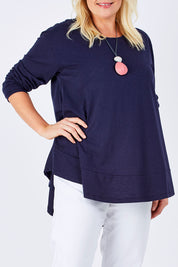 Model Natalie wearing size 16 of The Long Sleeve Swing Tee in colour DenimBlue (Blue), from the front, cropped image