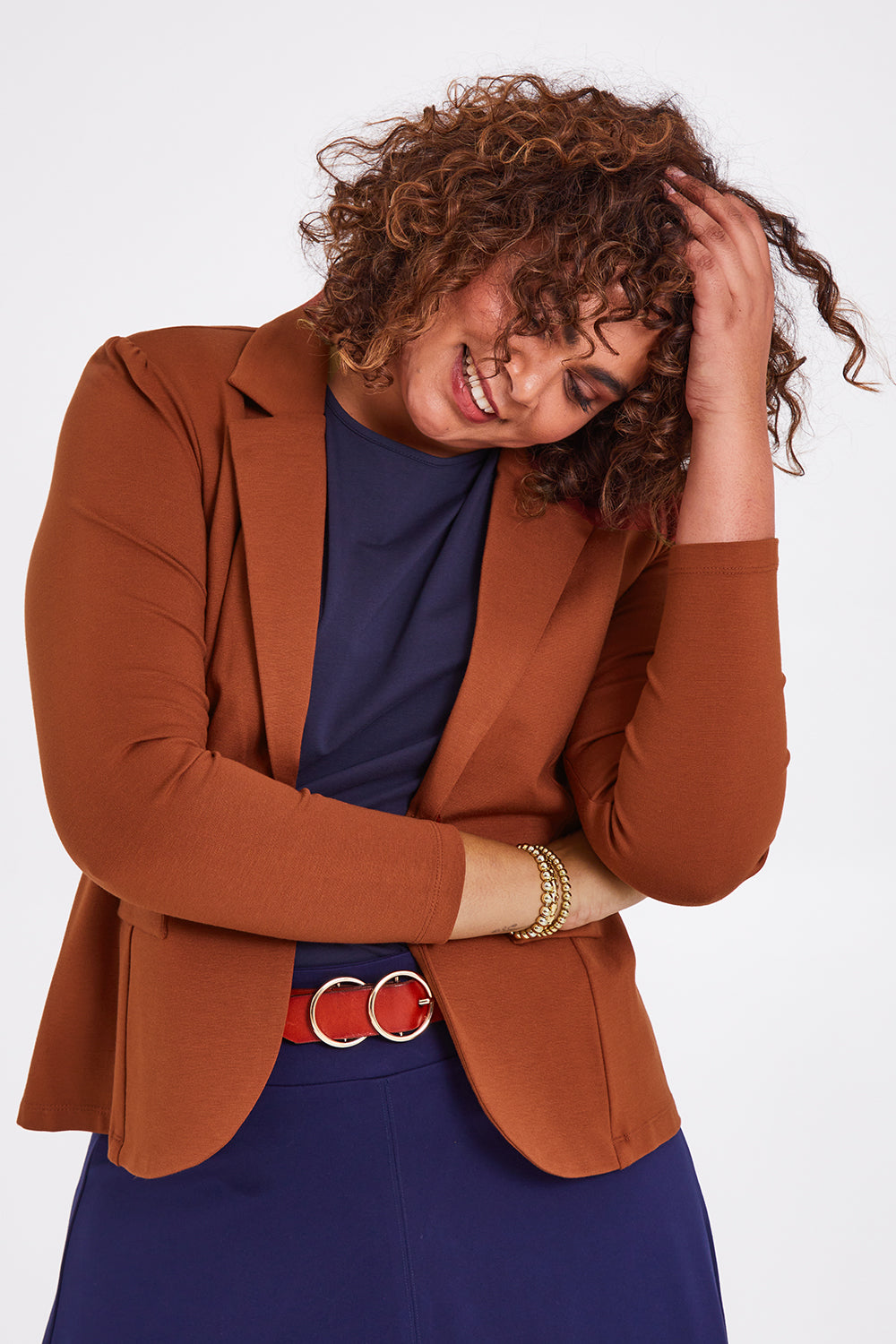 Model Anucia wearing size 14 of The Ponte Blazer in colour Ochre, from the front, cropped image