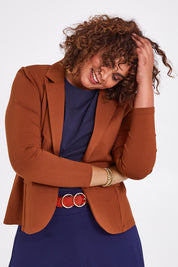 Model Anucia wearing size 14 of The Ponte Blazer in colour Ochre, from the front, cropped image