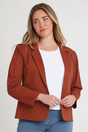 Model Chanel wearing size 16 of The Ponte Blazer in colour Ochre, from the front, cropped image